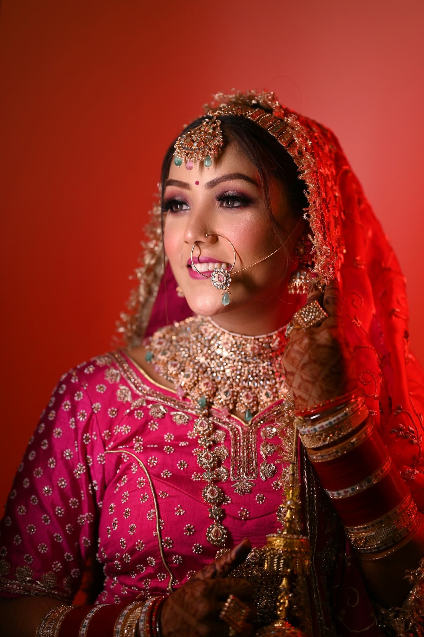 Indian bridal editorial portrait in warm red tones